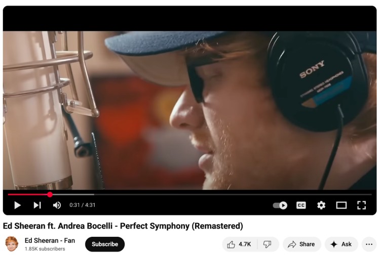 Ed Sheeran recording in a studio while wearing Sony MDR-7506 closed-backs headphones, positioned in front of a professional microphone.