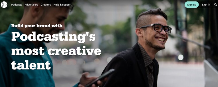 Screenshot of the Audioboom homepage showing two smiling creators, promoting the podcast platform as ideal for brands looking to collaborate with creative talent.