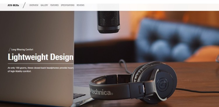 Audio-Technica headphones and a studio microphone on a desk setup designed for podcasters.