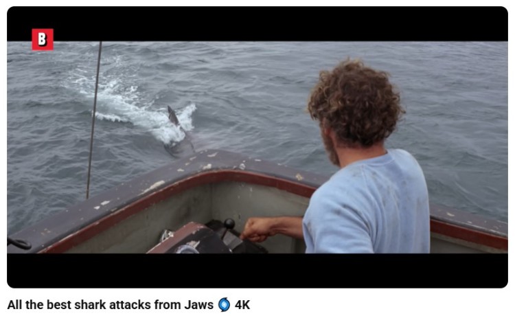 Scene from the movie Jaws showing a shark approaching a boat while the character remains unaware, illustrating how dramatic irony takes tension to another level in storytelling.
