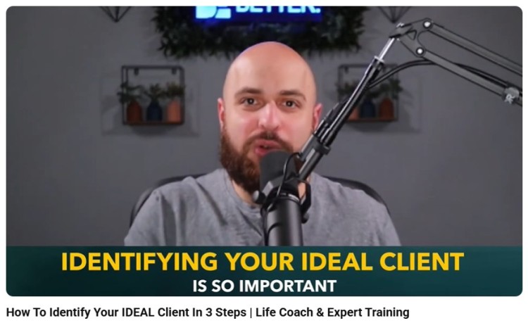 Coach speaking into a microphone during a training video about identifying your ideal client, demonstrating informative speaking techniques.