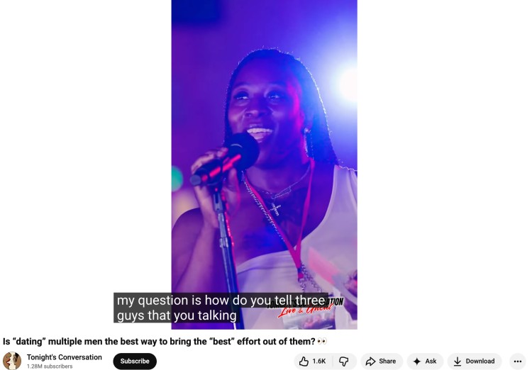 Speaker holding a microphone during a live talk sharing a thought-provoking question about relationships and communication