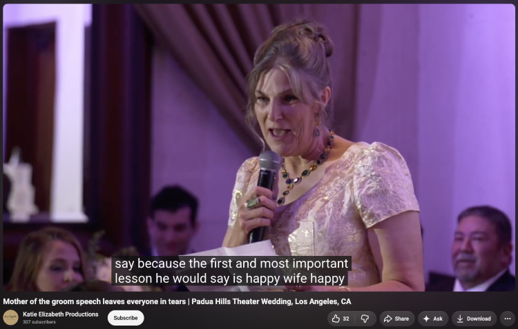 Mother of the groom holding a microphone and notes as she prepares to speak from the heart