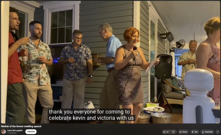 Mother of the groom holding a microphone as she says she would want to thank everyone attending the wedding